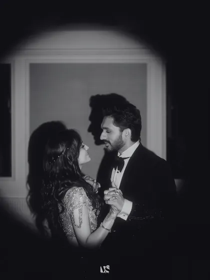A timeless black and white shot of a couple lost in their own world, dancing closely. The dramatic lighting and intimate framing highlight the deep connection and emotion that we focus on in our engagement photography.
