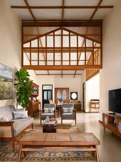 The living area of the restored Mount Pleasant Villa features a double-height space with an exposed timber-framed loft, blending traditional hill architecture with an open, modern feel.