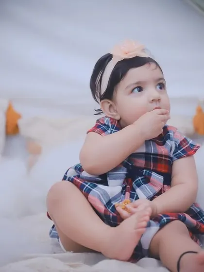 A candid moment of a toddler snacking during her photoshoot. These real-life moments add so much personality to the final gallery.