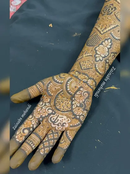 A full palm-to-forearm design for bride Musfira, featuring her name hidden in the intricate pattern.