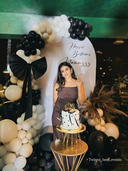 A beautiful portrait of Namratha Gowda at her birthday party. Our chic black and cream balloon decor with a large bow detail provided a stylish and modern backdrop for her photos.