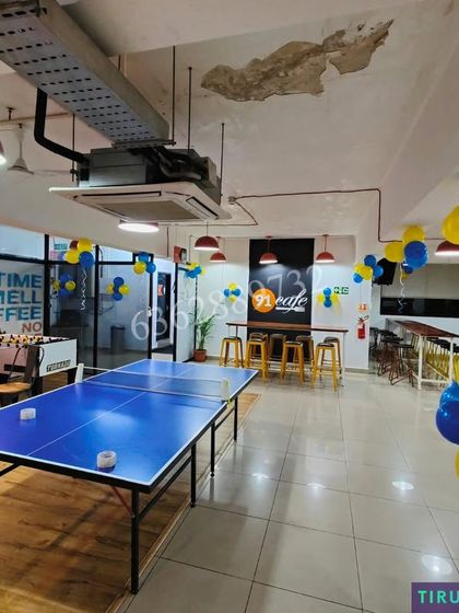 Decorating the recreational area of an office, including the space around the table tennis table, for a corporate event.