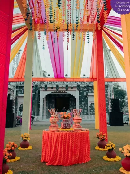 A classic and colorful outdoor Mehendi setup with vibrant drapes and traditional matkas. This design is perfect for a festive and high-energy celebration.