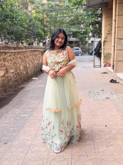The full view of this mint green lehenga shows the delicate floral embroidery on the skirt. It’s a very fresh and pretty look.