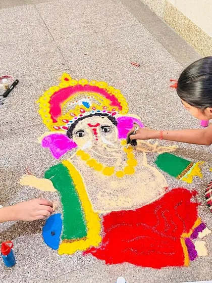 Students create a beautiful rangoli of Lord Ganesha using colored powders. Our Diwali celebrations include traditional art forms like rangoli, allowing students to connect with our cultural heritage through creative expression.