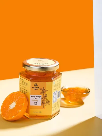 A minimalist and modern shot of honey orange tea concentrate using color blocking and hard light. This contemporary style is great for engaging a younger audience.