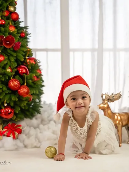 A crawling Santa. This dynamic shot captures the energy and fun of a Christmas-themed baby shoot.