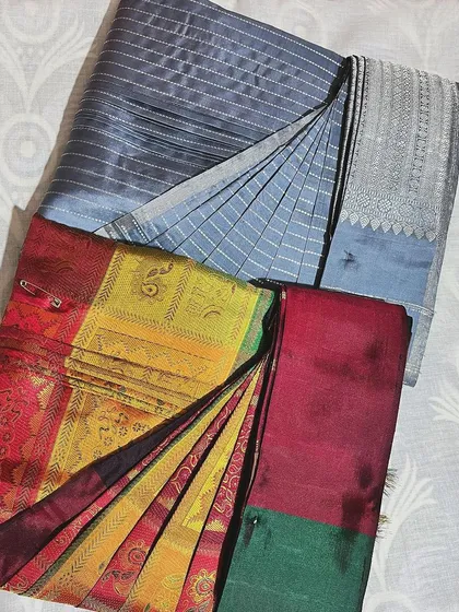 Another example of a grey cotton and a colorful silk saree, showing the versatility of the folding technique.