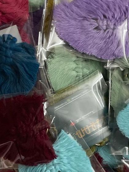 This box is filled with my leaf-shaped keychains in various shades of green, purple, and blue. Each one is individually packed.