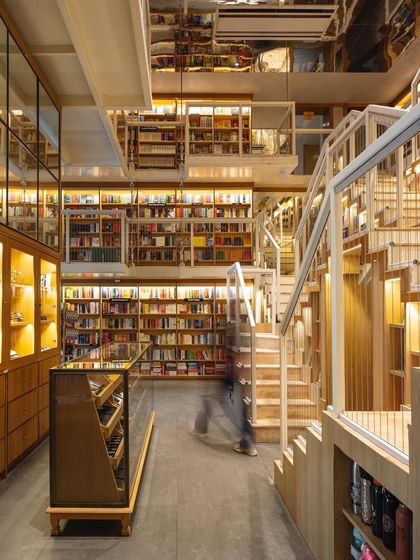 A view from the ground floor of The Story Project shows the multi-level design, with suspended walkways and staircases leading to different sections. This approach creates an immersive space that encourages movement and discovery.