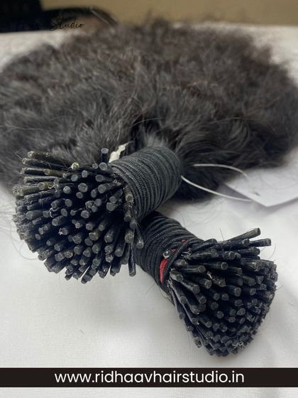 Two bundles of our I-Tip raw curly extensions, ready to be installed for a voluminous and bouncy look.