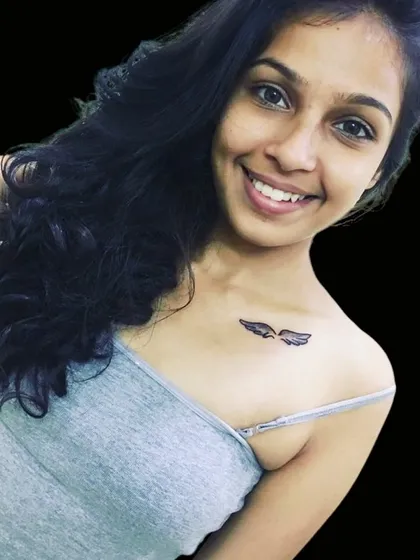 A small pair of angel wings on the collarbone.