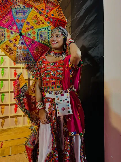 A front view of this classic red and white chaniya choli. The outfit features intricate embroidery and comes with a matching pouch for your phone and keys.