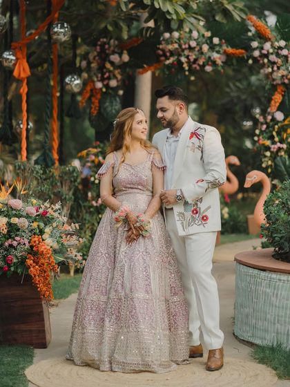 A lovely portrait of the couple at their garden-themed Mehendi. The lush greenery and floral decor provide a beautiful, natural backdrop for their love story.