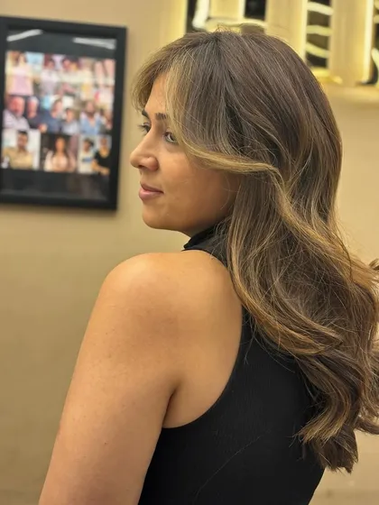 A side view of a client's hair, showing how the highlights are expertly blended to create a natural, sun-kissed effect.
