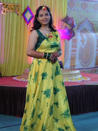 A full-length shot of the bride in her beautiful yellow haldi outfit, her mehendi complementing the look perfectly.