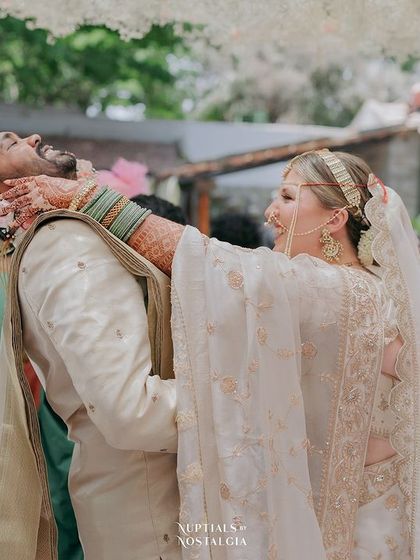 A playful moment during the 'varmala' ceremony, as the bride garlands the groom.