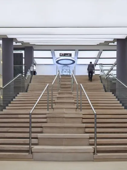 Another view of the grand interior staircase, showcasing the scale and modern aesthetic of the museum's public spaces.