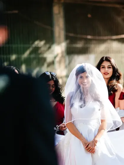 The first look from the groom's perspective. The bride's smile as she sees her husband-to-be is a moment of pure happiness.