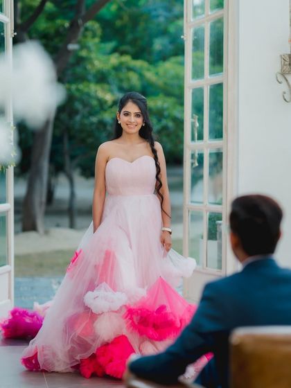 A "first look" style shot, capturing the bride's beautiful smile as her groom looks at her. It’s a moment filled with anticipation and love.