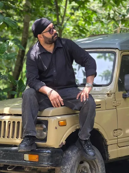 Posing on the jeep amidst the lush greenery of Jim Corbett National Park. This shot captures the essence of our adventure and wildlife photography tours.