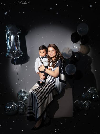 A magical mother and son portrait. The sparkly overlay and birthday props create a dreamy and celebratory feel for this special milestone.