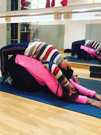 The bond between a mother and child is so special, and partner yoga is a beautiful way to deepen it. This supported backbend helps both people to open their hearts and trust one another.
