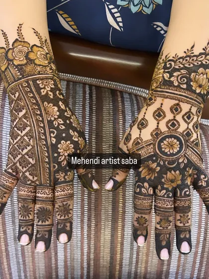 This design shows two different styles on each hand. One features a geometric pattern, while the other has a more organic, floral look, showcasing variety.