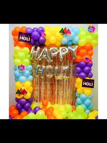I can create decorations for any festival, like this colorful setup for a Holi party. It features a vibrant balloon frame around a gold fringe curtain and 'Happy Holi' foil letters.