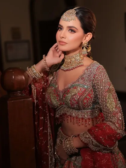 A regal pose showcasing a full-sleeved embroidered blouse. I styled this look to feel both traditional and powerful, perfect for a bride who loves heritage craftsmanship.