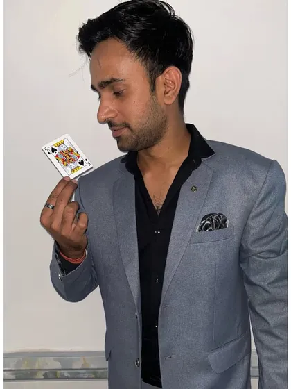 Holding a single card, the focus of the trick. The magic is in the details.