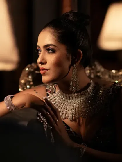 An elegant and classic bridal portrait. The warm, soft lighting from the lamp creates a sophisticated and intimate atmosphere.