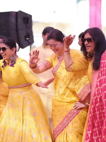 Dancing with the ladies of the family, sunglasses on and not a care in the world. A daytime Haldi party is all about these carefree moments.