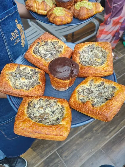 A platter of savory mushroom danishes. This shot highlights the delicious-looking food available at the event, enticing people to attend future ones.