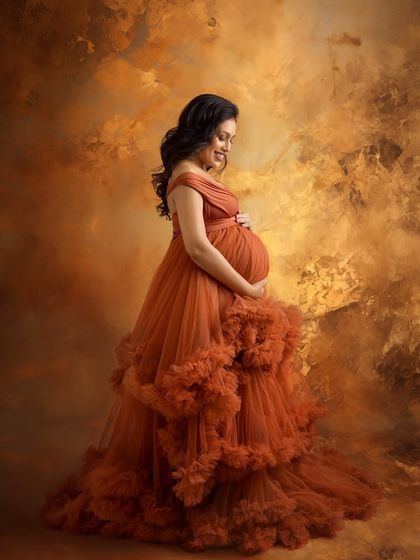 A beautiful portrait showing her looking down at her bump with a gentle smile.