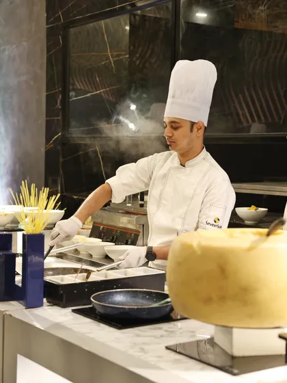 The heart of our Italian station: a chef preparing fresh pasta, with a large wheel of Parmesan ready to add the finishing touch of rich, nutty flavour.