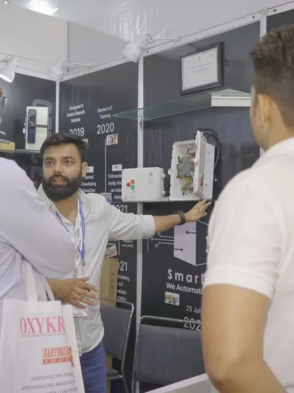 Explaining the technical details of our smart automation systems to an interested visitor. We are always happy to dive deep into the technology that powers our products.
