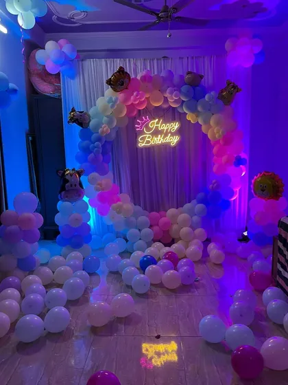 The full setup, featuring a pastel balloon ring, a 'Happy Birthday' neon sign, and cute animal foil balloons.