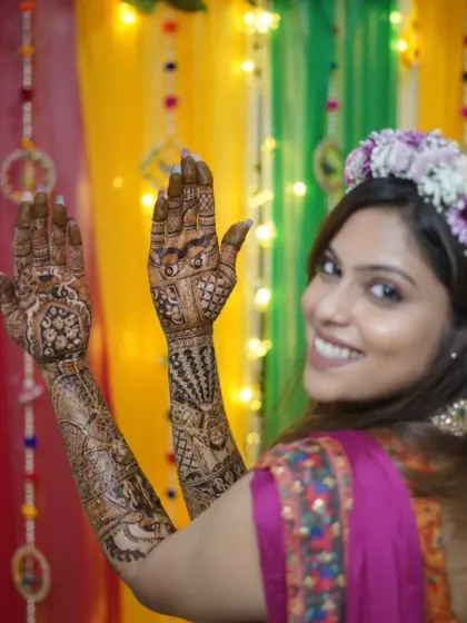 A beautiful shot of a bride-to-be, smiling as she shows her intricate mehndi. Capturing these happy moments is a joy.