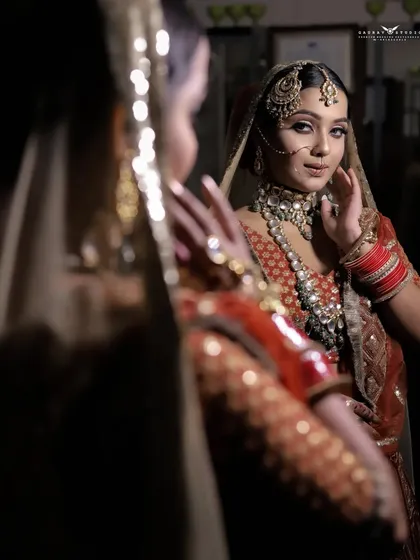 A close-up of the bride's reflection, capturing her expression and the details of her jewelry.