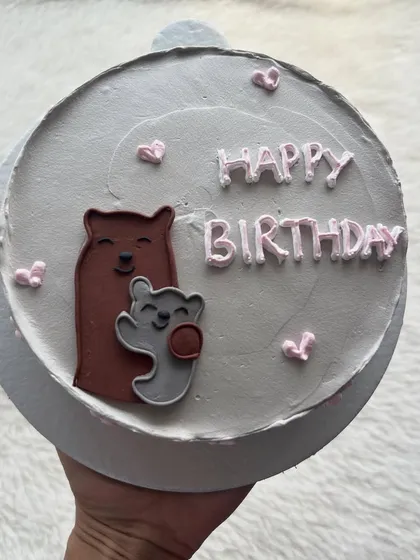 A cute bento cake with a hand-painted bear and cub. It's a sweet design for a birthday or to celebrate a special bond.