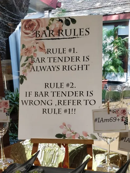 We love to have fun with our clients. This custom sign for a 70th birthday party lays down the "Bar Rules," including "Rule #1: Bartender is always right," adding a playful touch to the celebration.