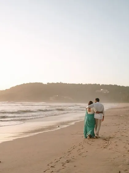 Walking into the future, together. A serene beach at sunset provides a timeless backdrop for love stories, showing our expertise in destination and golden hour couple portraits.