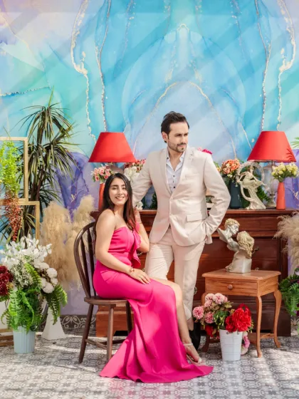 A stylish portrait against a vibrant, artistic blue backdrop. The couple's confident poses and the colorful setting create a modern and fashionable pre-wedding photo.