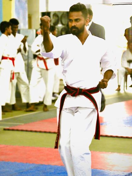 Executing a block during a kata performance. In competition, every movement must be precise, powerful, and filled with intention.