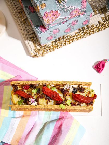 An overhead view of our savoury puff tart, showcasing its flaky layers and colourful, gourmet filling.