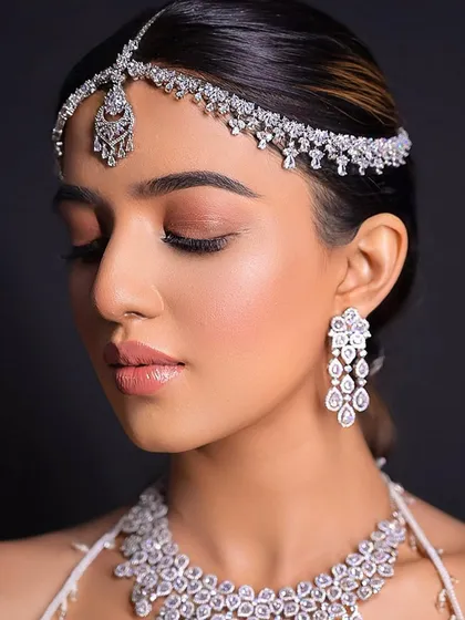 A close-up of the bride's flawless makeup and the sleekness of her hair.