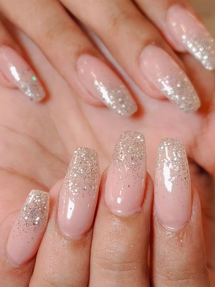 A soft and pretty glitter ombre. This look uses a fine silver glitter that fades into a sheer pink base for a delicate and sparkling effect.