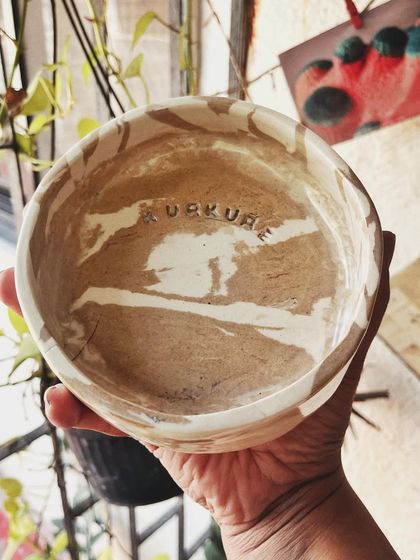 This student started with a one-time workshop and came back to begin his pottery journey. His pieces, like the quirky radio and the massive planter, are full of fun and character.