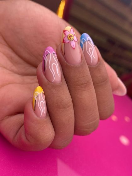 A fun and playful design with a fiery edge. This set combines colorful French tips with hand-painted flame details and a smiley-face flower for a quirky, trendy look.